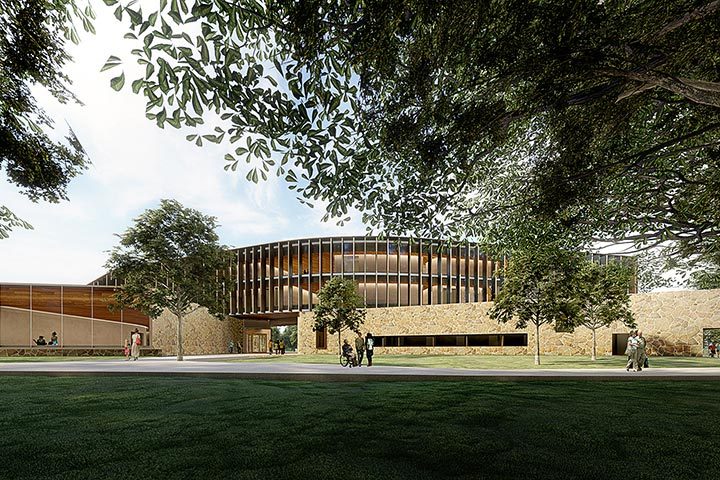 Whole Health Institute Building Modern circular building with glass, trees, greenery, path, pedestrians, and cyclists in view.