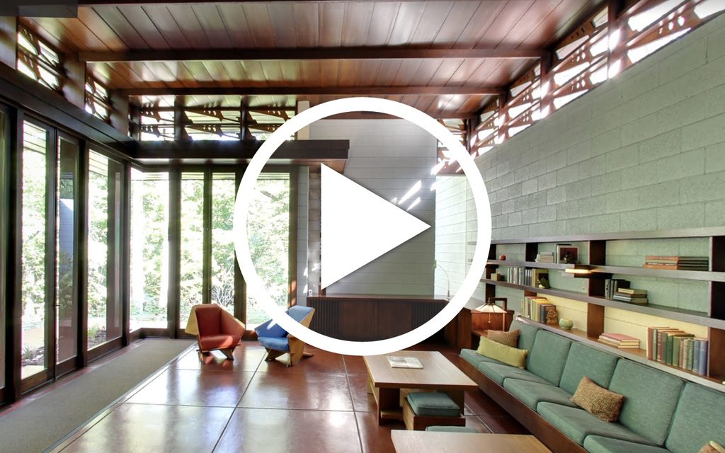 Frank Lloyd Wright Bachman-Wilson House Virtual Tour Modern living room with large windows, wooden furnishings, colorful seating, and natural light.