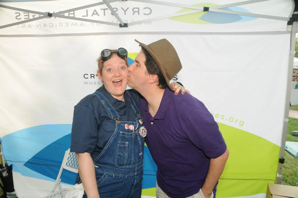 Heather Marie Wells a staff member dressed as rosie the riveter receives a kiss from her husband