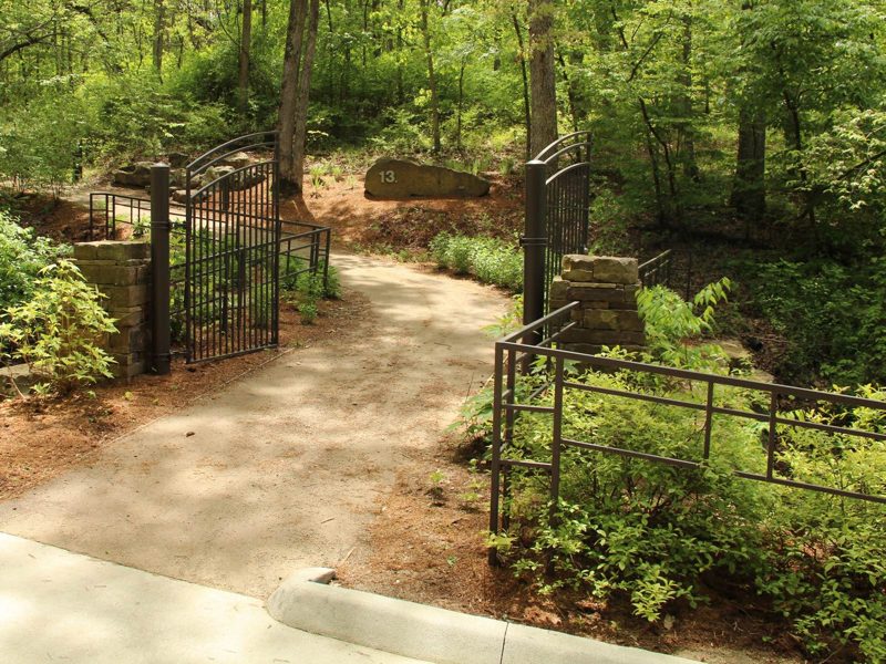 Enfield Trail Intersection of paved trails with one leading into forest