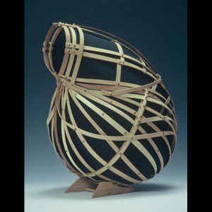 Basket by Leon Niehues Interwoven wooden slats form a rounded, basket-like sculpture on a small base.