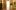 Room with wood walls, painted tools, landscapes, doorway to lit area, trompe-l'œil style.