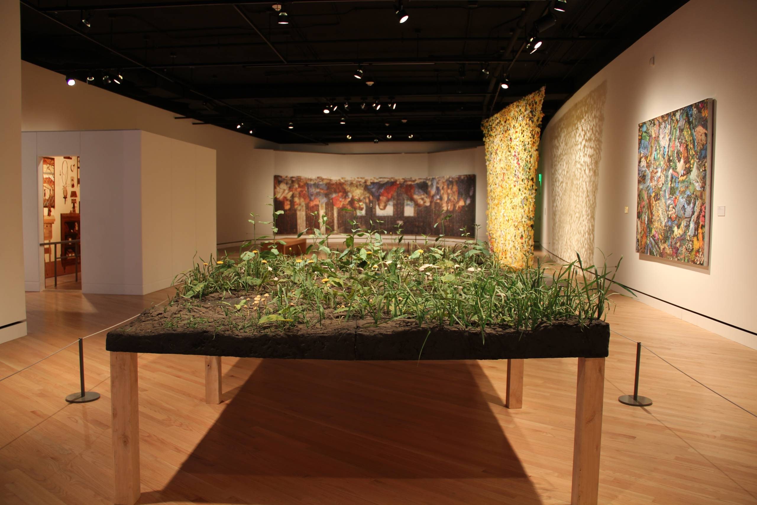 Roxy Paine, Bad Lawn, 1998, Epoxy, PVC, polymer, steel, wood, PETG, lacquer, oil paint, and earth, 48 x 120 x 84 in. (121.9 x 304.8 x 213.4 cm). Crystal Bridges Museum of American Art, Bentonville, Arkansas, 2011.2 picture of a gallery from the exhibition wonder world, including a sculpture of a table with grass and dirt on top of it